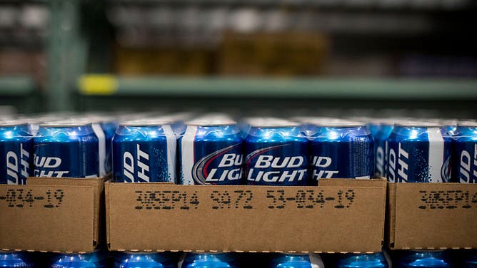 Cans of Anheuser-Busch Bud Light brand beer sit in a warehouse and the company is now trying to give it away for free.