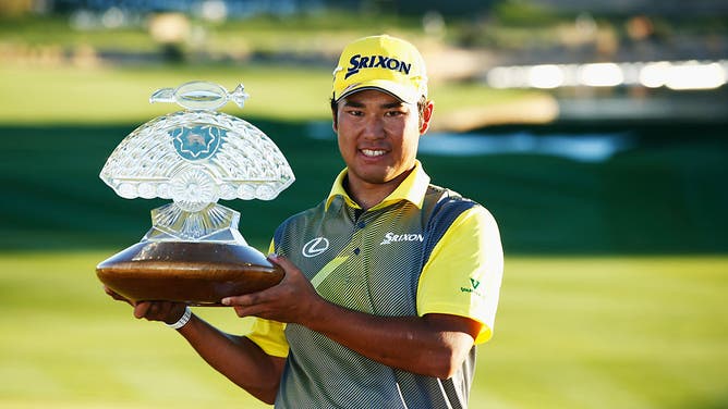 Hideki Matsuyama poses with the winners trophy on the 18th hole during the final round of the Waste Management Phoenix Open at TPC Scottsdale in Arizona.