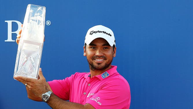 Jason Day celebrates with the trophy after winning during the final round of THE PLAYERS Championship at TPC Sawgrass in Ponte Vedra Beach, Florida.
