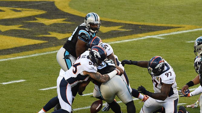 Shane Ray of the Denver Broncos tackles Mike Tolbert of the Carolina Panthers and forces a fumble during the first half of Super Bowl 50.