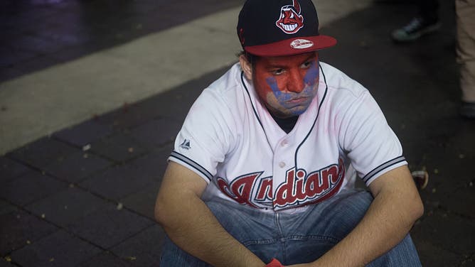 Sad fan wearing Cleveland Indians gear and unhappy about the change to Guardians that ESPN helped force.