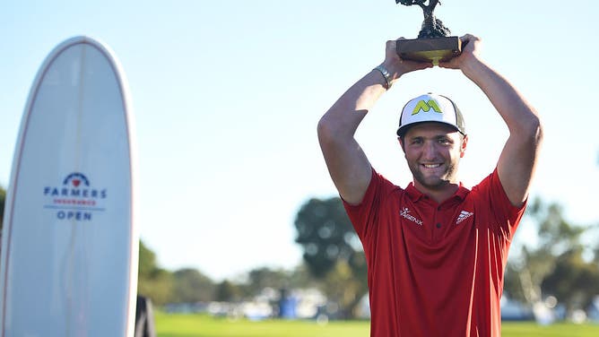 Jon Rahm holds up the trophy for winning the 2017 Farmers Insurance Open at Torrey Pines Municipal Golf Course in San Diego, California.