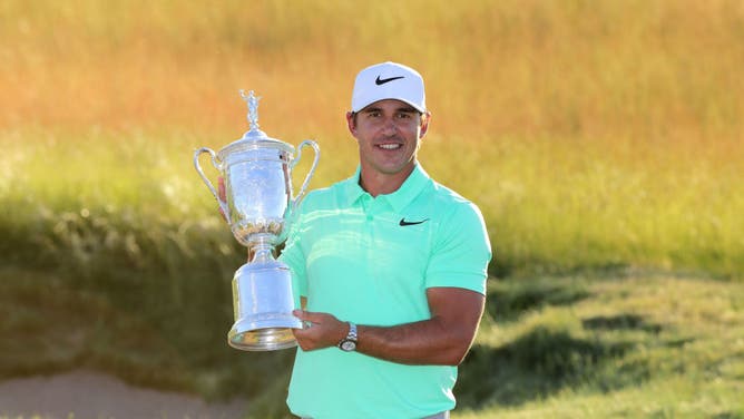 Brooks Koepka poses with the winner's trophy after his victory at the 2017 U.S. Open at Erin Hills in Wisconsin.