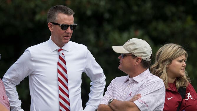 Alabama athletic director Greg Byrne talks with people before a college football game.
