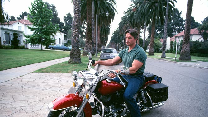 Arnold Schwarzenegger in 1982 is friendly and obliging with the press as 'Conan the Barbarian' is about to be released. During the day-long shoot, Arnold rode his Harley Davidson and looks at slides in his Santa Monica home.
