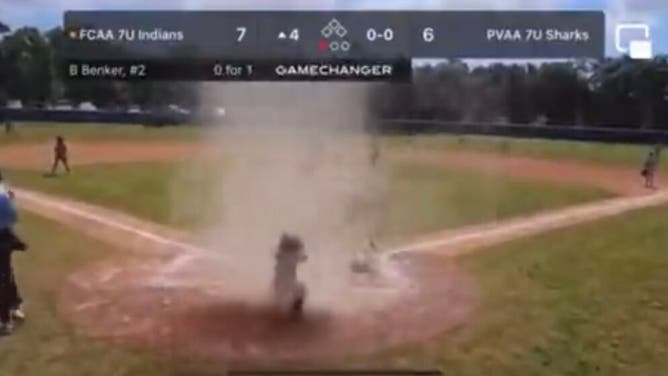 Young baseball catcher stuck in 'Dustnado', Umpire saves the day