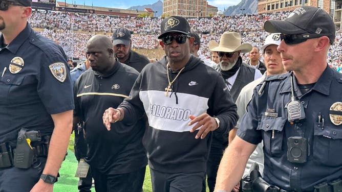 Deion Sanders walks off the field, following the loss t USC