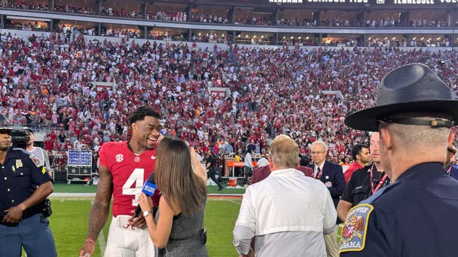 Jalie Milroe gives Nick Saban a cigar, which Saban then gave to his SID