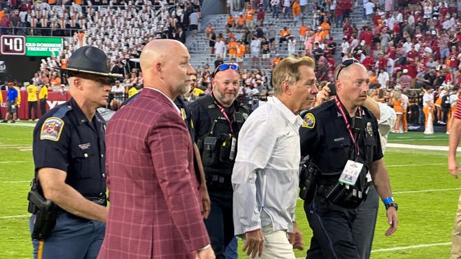 Nick Saban exits the field, following a celebration with the student section