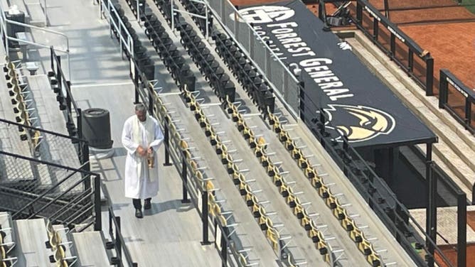 Priest Walks around Southern Miss Stadium, Blessing Every Inch With Holy Water Courtesy of Blake Levine