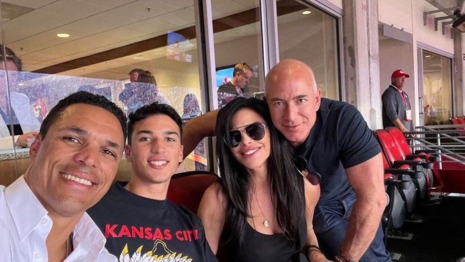 Flex Bezos showing off the guns with girlfriend Lauren Sanchez and her son Nikko along with Nikko's father Tony Gonzalez at the Chargers-Chiefs game