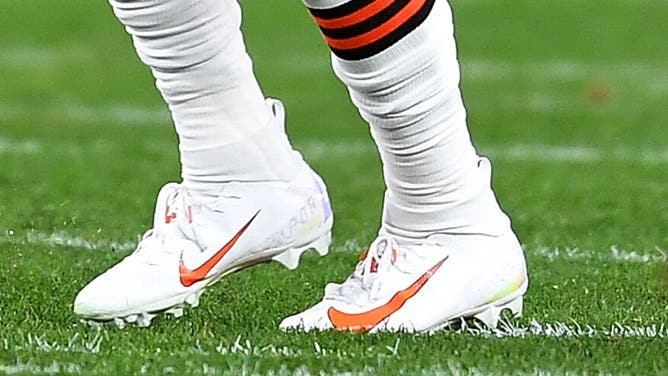 Baker Mayfield wearing, presumably, the same cleats as above, but painted for his new team.