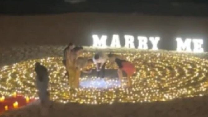 Over-The-Top Beach Proposal Goes Wrong When They Lose The Ring In The Sand