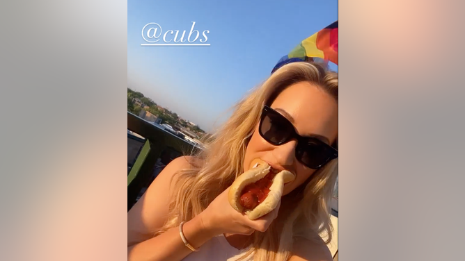Paige Spiranac eating a hot dog