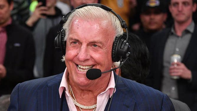 Ric Flair smiles with headset on