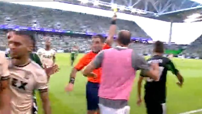 Ref Holds Yellow Card During Brawl
