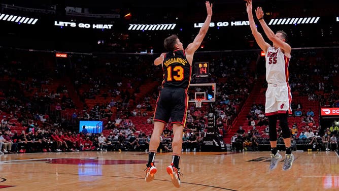 Heat SG Duncan Robinson shoots a 3-pointer over Atlanta Hawks SG Bogdan Bogdanovic at the then-FTX Arena in Miami
