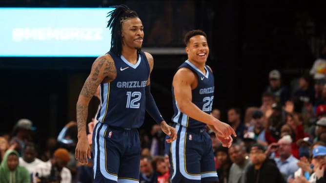 Grizzlies PG Ja Morant and SG Desmond Bane smile after scoring a bucket vs. the Orlando Magic at FedExForum in Memphis, Tennessee.