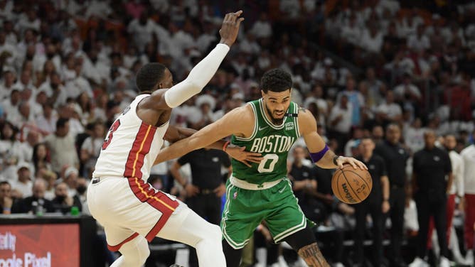 Boston Celtics SF Jayson Tatum drives to the basket on Heat big Bam Adebayo during Game 7 of the 2022 NBA Eastern Conference Finals in Miami.