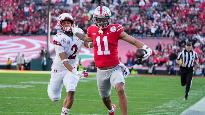 Ohio State WR Jaxon Smith-Njigba fends off Utah CB Micah Bernard as he races to the end zone for a TD during the 2022 Rose Bowl in Pasadena, California.