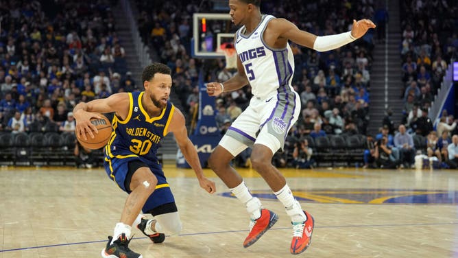 Warriors guard Stephen Curry dribbles around Kings PG De'Aaron Fox during the 3rd quarter in Game 5 of their NBA playoff series at Chase Center.