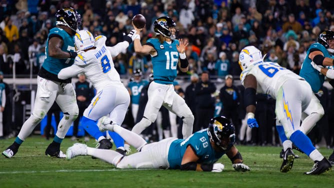 Jacksonville Jaguars QB Trevor Lawrence drops back to pass vs. the Los Angeles Chargers during the 2023 AFC Wild Card game at TIAA Bank Field in Florida.