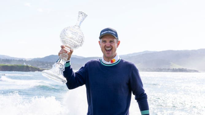 Justin Rose poses with the trophy on the 18th hole of the final round of the 2023 AT&T Pebble Beach Pro-Am.