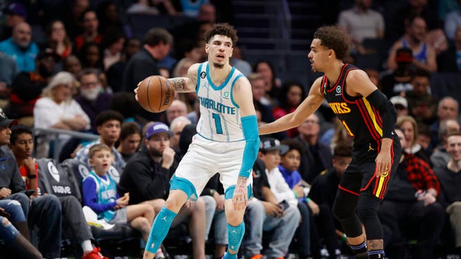 Hornets PG LaMelo Ball handles the ball vs. Atlanta Hawks PG Trae Young at the Spectrum Center in Charlotte, North Carolina.