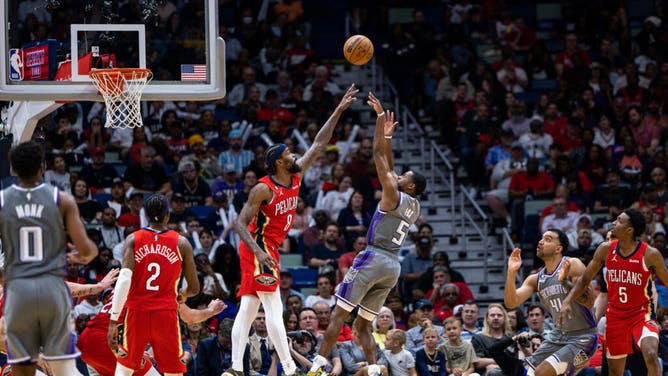 Sacramento Kings PG De'Aaron Fox shoots a fadeaway over Pelicans SF Naji Marshall at Smoothie King Center in New Orleans.