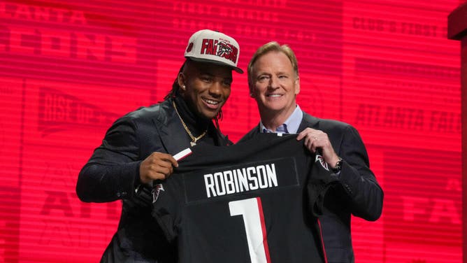 Former Texas Longhorns RB Bijan Robinson with NFL commissioner Roger Goodell after being taken 8th by the Falcons in the 2023 NFL Draft.
