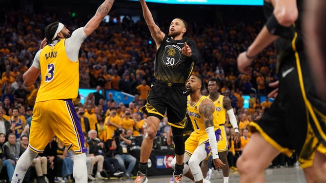 Warriors G Stephen Curry has his shot blocked by Lakers big Anthony Davis in the 4th quarter during Game 1 of the 2023 NBA playoffs at the Chase Center.