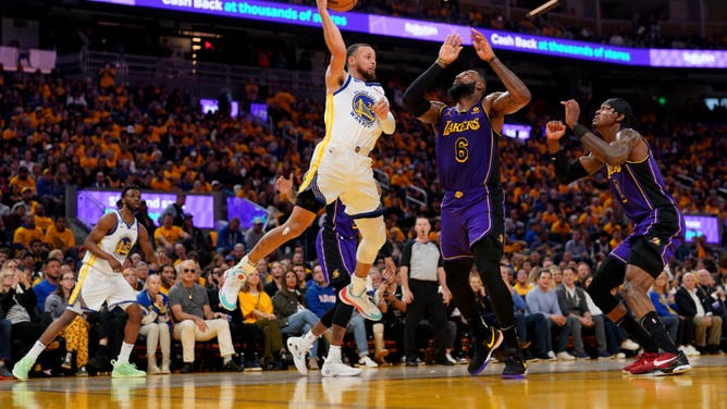 Warriors legend Stephen Curry passes the ball over Los Angeles Lakers All-Star LeBron James in Game 2 of the 2023 NBA playoffs at the Chase Center in San Francisco.