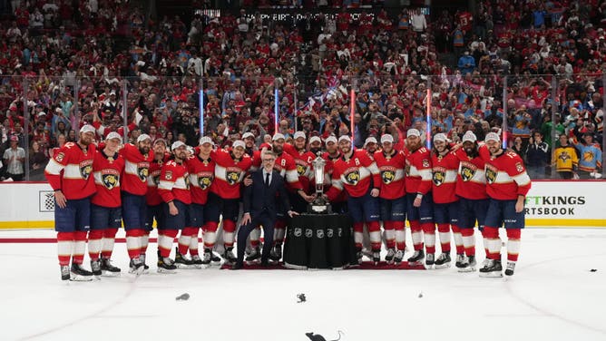 Florida Panthers teammates pose for a photo with the Prince of Wales trophy after defeating the Carolina Hurricanes in the Eastern Conference Finals of the 2023 Stanley Cup Playoffs.