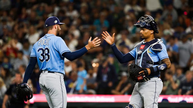 Tampa Bay Rays reliever Colin Poche daps up Rays C Christian Bethancourt following 15-4 victory at the Seattle Mariners at T-Mobile Park.