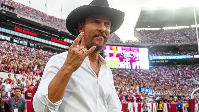 Actor Matthew McConaughey holds up the horns during the Texas Longhorns vs. Alabama Crimson Tide game at Bryant-Denny Stadium in Tuscaloosa, Alabama.