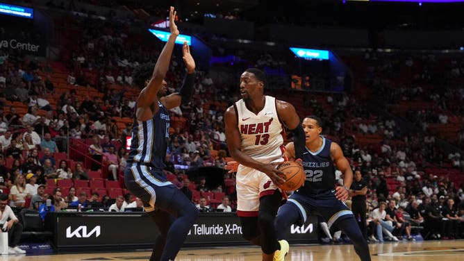 Miami Heat big Bam Adebayo drives the paint against Memphis Grizzlies PF Jaren Jackson Jr. and SG Desmond Bane at Kaseya Center in Miami.