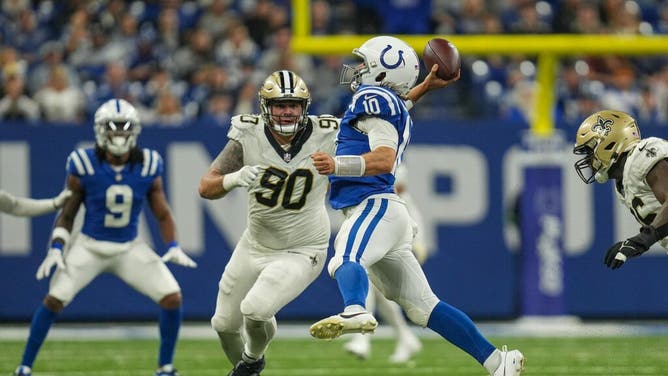Indianapolis Colts QB Gardner Minshew II  gets rid of the ball under pressure by the New Orleans Saints at Lucas Oil Stadium in Indiana.