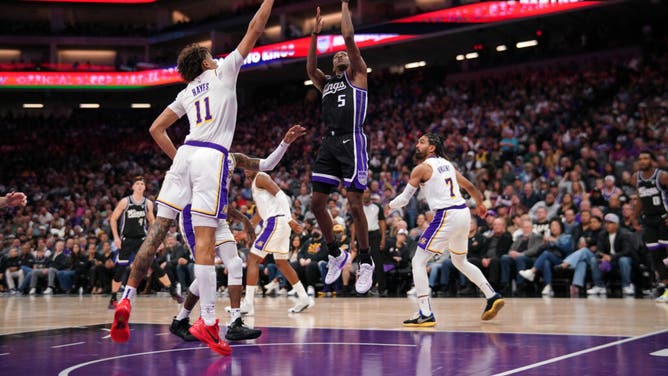 Kings PG De'Aaron Fox shoots a floater over Los Angeles Lakers big Jaxon Hayes at the Golden 1 Center in Sacramento, California.