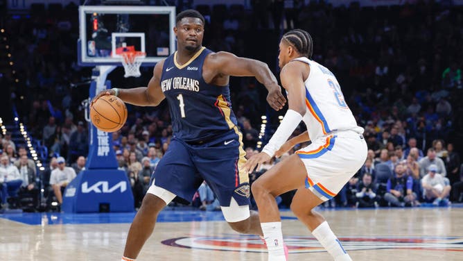 New Orleans Pelicans PF Zion Williamson drives down the court on Thunder SG Aaron Wiggins in an NBA game at Paycom Center in Oklahoma City.