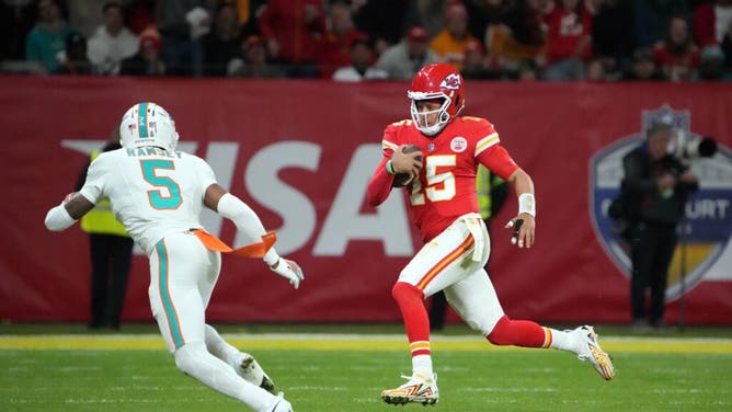 Kansas City Chiefs QB Patrick Mahomes carries the ball with Miami Dolphins CB Jalen Ramsey trying to tackle him during an NFL International Series game at Deutsche Bank Park in Munich, Germany