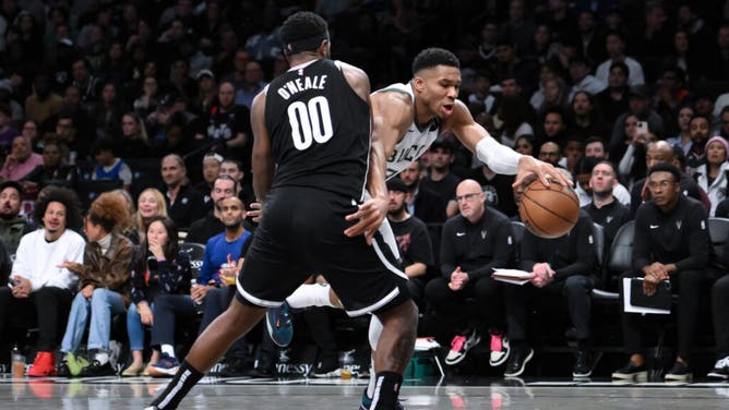 Milwaukee Bucks PF Giannis Antetokounmpo tries to get past Nets forward Royce O'Neale in an NBA game at Barclays Center in Brooklyn.