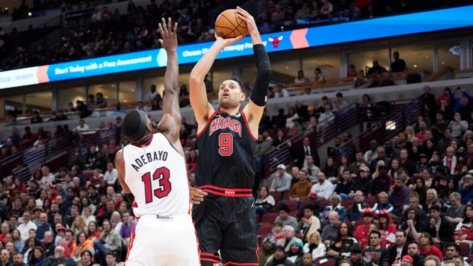 Bulls C Nikola Vucevic shoots over Miami Heat big Bam Adebayo at United Center in Chicago.