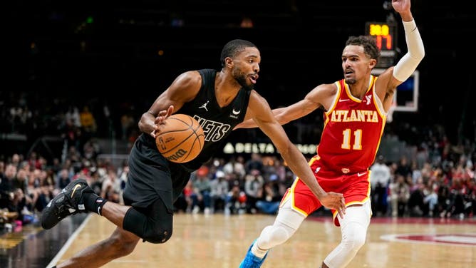 Brooklyn Nets SF Mikal Bridges drives to the hole on Hawks PG Trae Young at State Farm Arena in Atlanta.