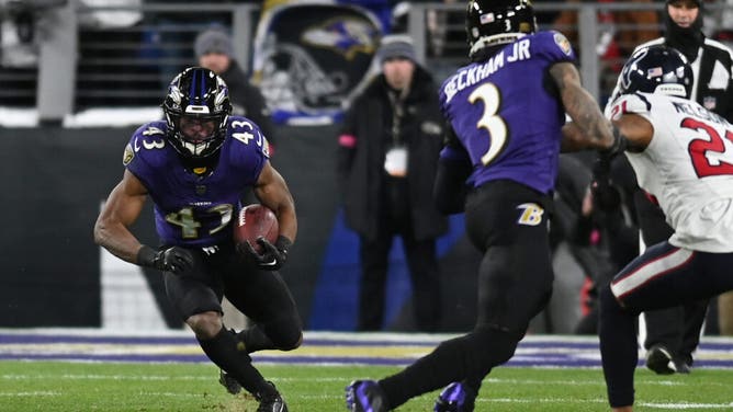 Baltimore Ravens RB Justice Hill rushes against the Houston Texans in the 2024 AFC divisional round game at M&T Bank Stadium.