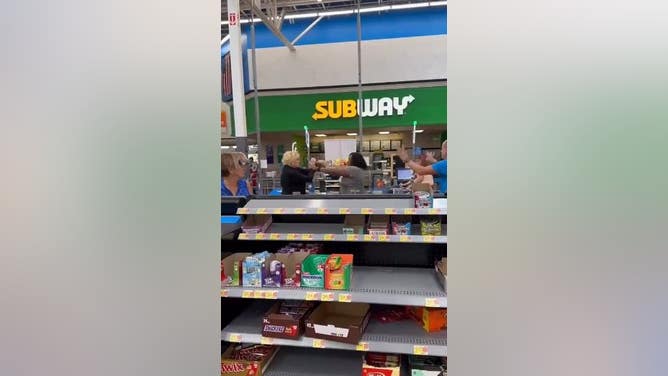 Two Middle Aged Women Go Toe-To-Toe At The Self-Checkouts At Walmart