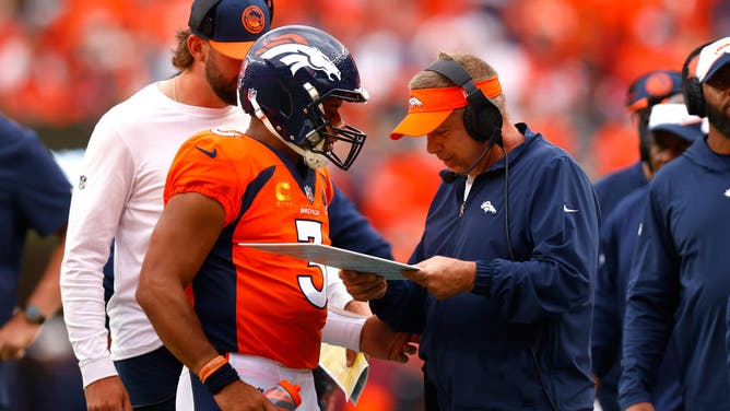 Broncos QB Russell Wilson talks to head coach Sean Payton vs. the Las Vegas Raiders at Empower Field At Mile High in Denver.