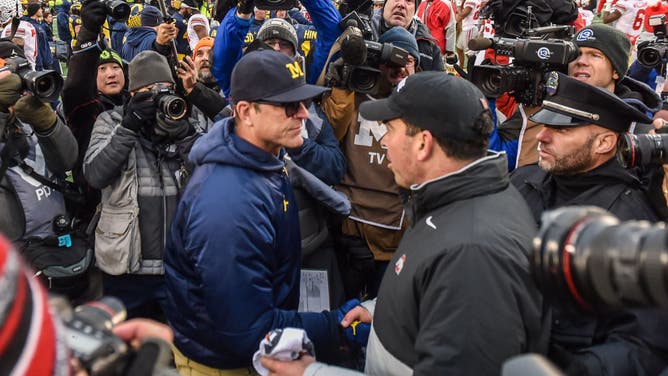 Jim Harbaugh and Ryan Day shake hands following the Michigan vs. Ohio State game