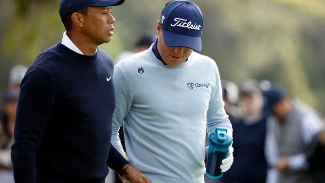 Tiger Woods jokingly hands Justin Thomas a tampon after outdriving him on the 9th hole during the first round of the The Genesis Invitational.