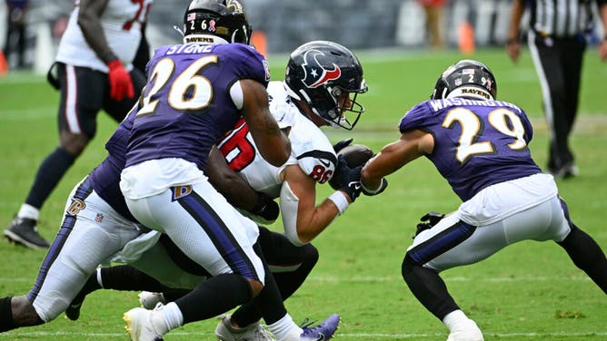 Ravens safety Ar'Darius Washington breaks up a pass thrown to Houston Texans TE Dalton Schultz at M&T Bank Stadium in Baltimore, Maryland.