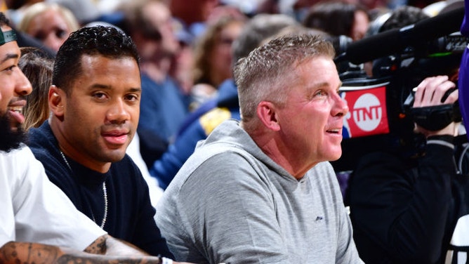 Denver Broncos QB Russell Wilson and head coach Sean Payton look on during a Denver Nuggets game.